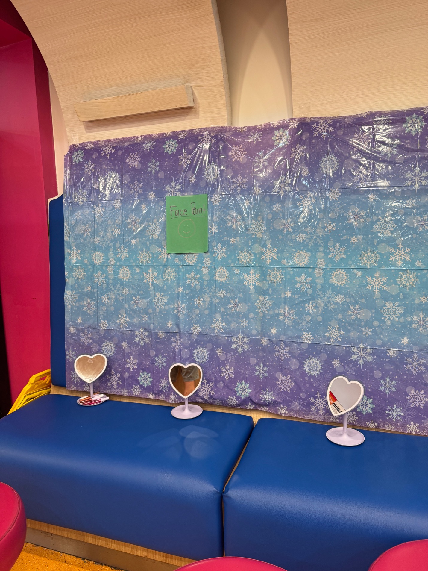 Snowflake tablecloth on blue bench seating with heart-shaped mirrors