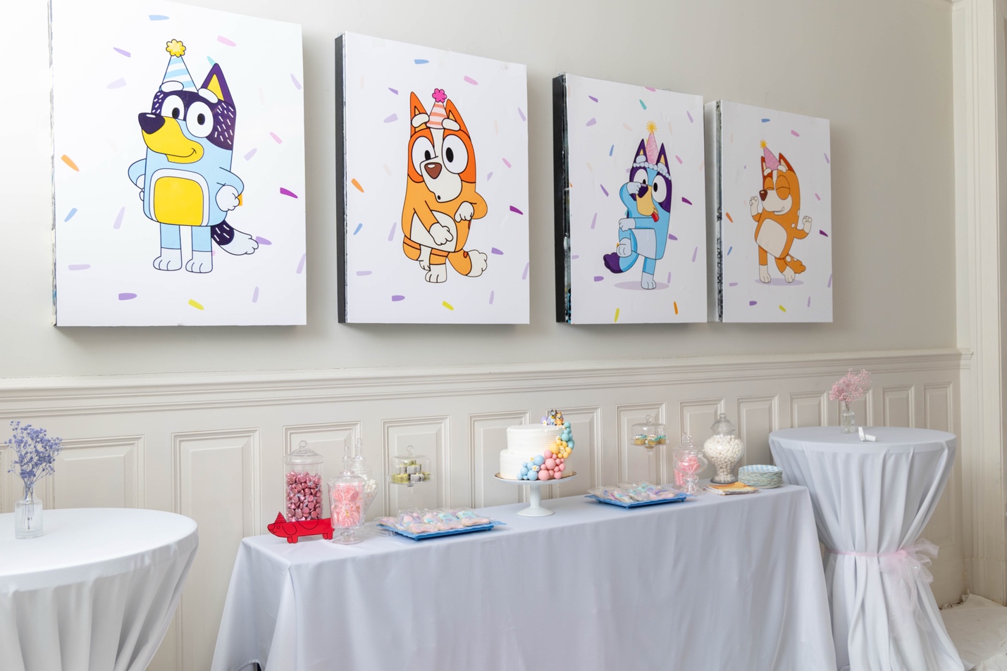 Preview of the four 30×40 Heeler family canvas panels — Bluey, Bingo, Chilli, and Bandit in party hats